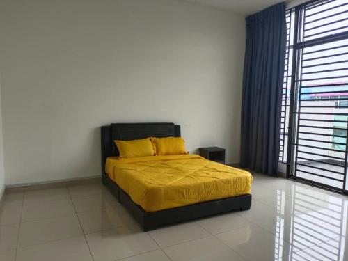 Bandar PenawarHomestay Desaru Utama @Escadia的一间卧室配有一张带黄色床单的床和一扇窗户。