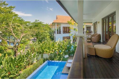 岘港Danang Pool Villas Resort & Spa My Khe Beach的一个带游泳池的别墅的阳台