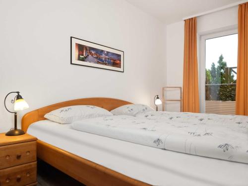 蒂门多夫Ferienwohnungen Fischerstieg Pier 17的卧室配有一张大白色床和窗户