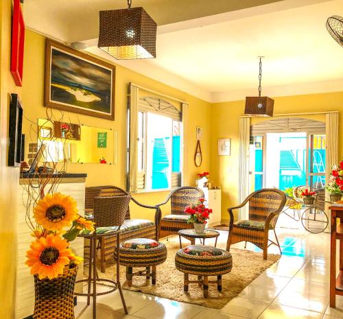 圣塔伦Pousada Casa do Ivo Santarém的客厅配有椅子和带向日葵的桌子