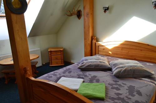 卡沙瓦Motelis Aka的一间卧室配有一张带两个枕头的木床
