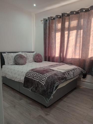 Hatch EndGood priced double bed rooms in harrow with shared bathrooms的一间卧室配有床和带窗帘的窗户