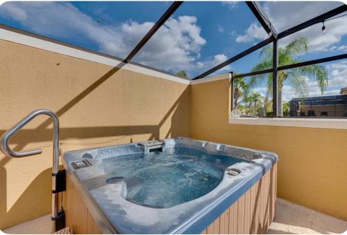 基西米Welcome to Villa Azul, your home away from home!的带大窗户的客房内的热水浴池
