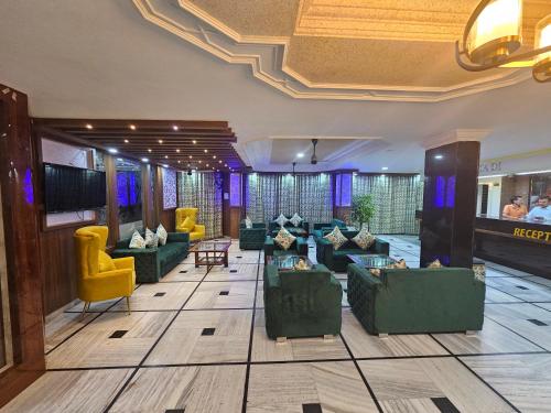 格德拉Hotel Bhawani International的大堂设有绿色沙发和黄色椅子