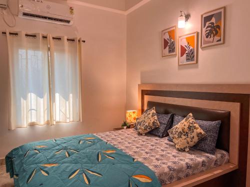 安君纳Arzu Homes的一间卧室设有一张床和一个窗口