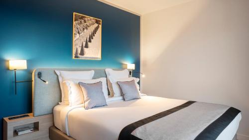 略桑Residhome Sénart的卧室配有白色大床和蓝色的墙壁