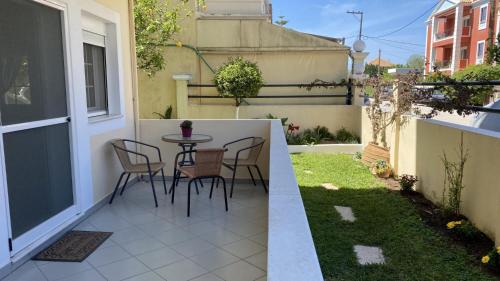 雷夫卡达镇Lefkada Blue - Apartments的阳台设有带桌椅的小天井。