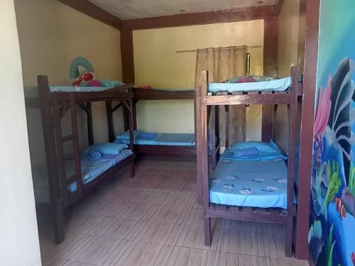 马拉帕斯加Malapascua Be One Guesthouse的一间设有三张双层床的客房