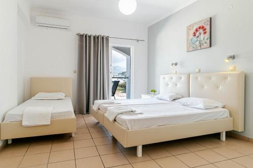 古维亚Porto Marina Aparthotel的带窗户的客房内的两张床