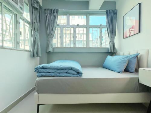 香港Student Accommodation - 26 Man Yuen Street的配有2扇窗户的客房内的1张床