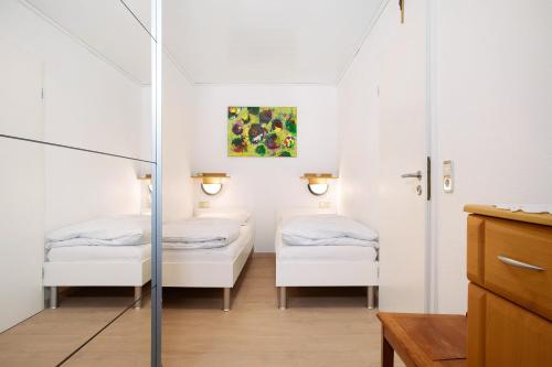 瓦瑟堡Haus Loser的小房间设有两张床和镜子