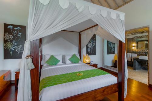 塞米亚克拉玛西塔别墅酒店的一间卧室配有一张带天蓬的床