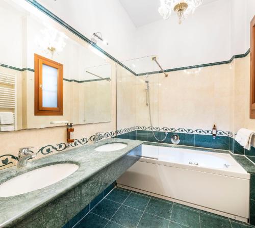 威尼斯都灵诺酒店的一间带两个盥洗盆和大镜子的浴室