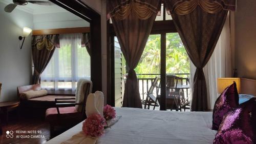珍南海滩Villa Dalam laut 530的一间卧室配有一张床,客厅配有窗户