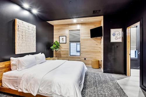 新奥尔良Nova Rooftop Villa的卧室配有白色的床和黑色墙壁