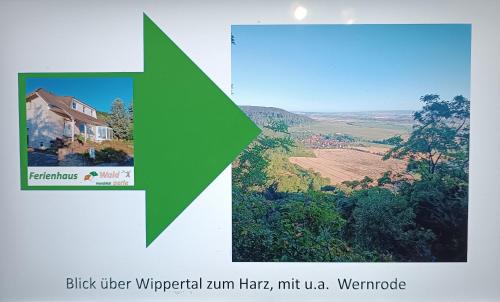 WernrodeFerienhaus Waldperle Harzblick的一张有绿色箭头的房子的照片