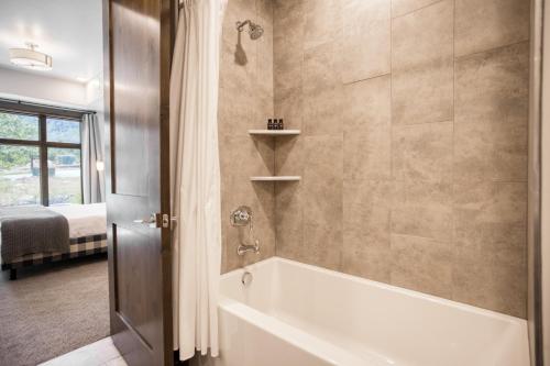 帕克城Chicane by AvantStay Close to the Ski Slopes in this Majestic Home in Park City的一间带白色浴缸的浴室和一间卧室