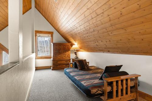特柳赖德Russell Home by AvantStay Expansive Deck Stunning Views Hot Tub的一间卧室设有一张床和木制天花板