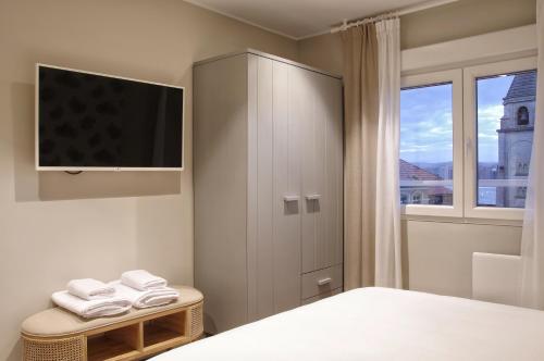 希洪Apartamentos Bahia San Lorenzo的一间卧室设有电视和窗户。