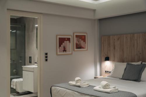 里奥Vialmar Premium Apartments的一间卧室配有带毛巾的床