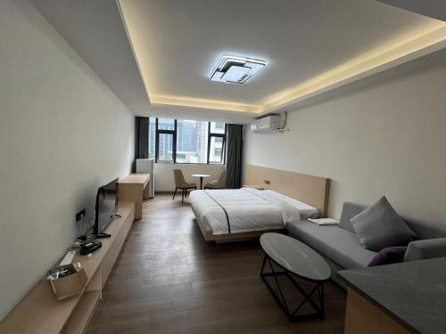 深圳WESU微宿服务公寓(深圳松坪山科技园店)的酒店客房,配有床和沙发