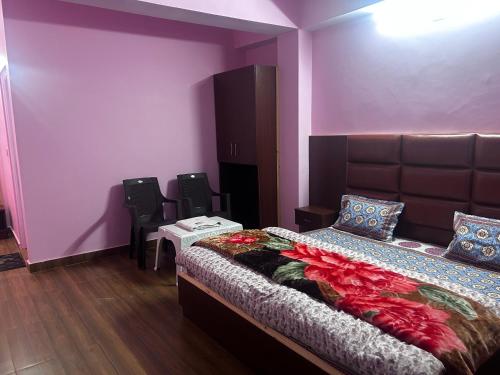 西姆拉Shimla Hills Apartments 2BHK的一间卧室配有一张带紫色墙壁和椅子的床