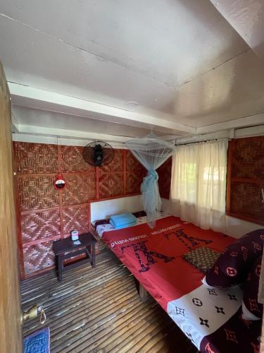 BatuanFely's Homestay的一间卧室,卧室内设有一张红色的大床
