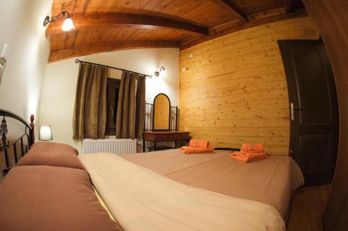 阿拉霍瓦山谷精品小屋度假屋的一间带两张床铺的卧室,位于带木墙的房间内