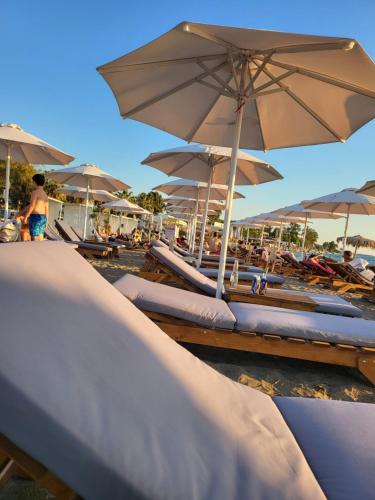 里奥Βίλα Σια的海滩上一组带遮阳伞的躺椅