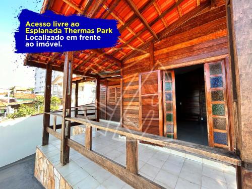 热河市Casa Para Temporada - Com Acesso ao Rio Thermal的一座木质建筑,前面有标志