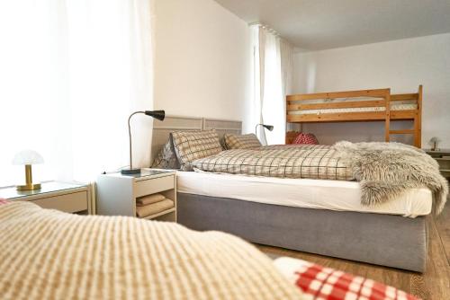 DärligenFamily room by Interlaken Parking的一间卧室配有两张床和一张带台灯的桌子