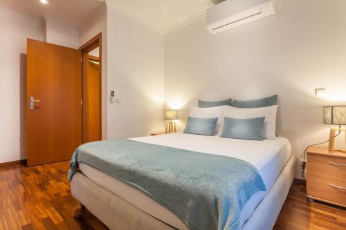 丰沙尔Blue Sky的一间卧室配有一张带蓝色枕头的大床