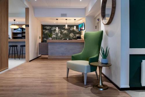 欧赖欧赖勒湖贝斯特韦斯特酒店的客厅配有绿色椅子和柜台