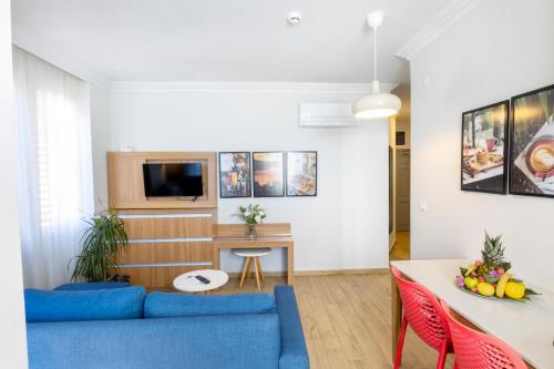 阿拉尼亚Comfort Suites的客厅配有蓝色的沙发和桌子