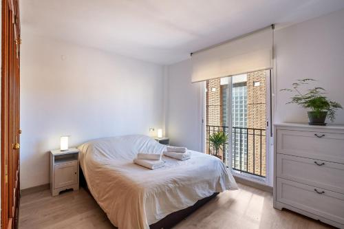 格拉纳达Casa Mirador Alquería的白色的卧室设有床和窗户