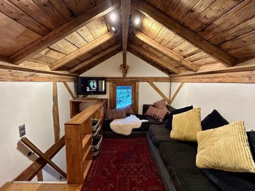 夏蒙尼-勃朗峰Gorgeous Mini-Chalet Chamonix的带沙发和木制天花板的客厅
