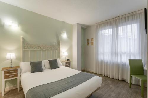 萨莫拉Alda Centro Zamora的卧室配有白色的床和窗户。