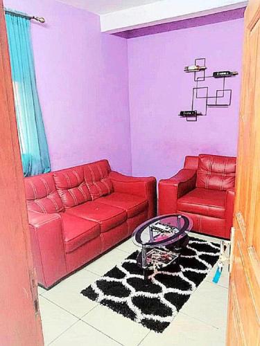 杜阿拉Residence Sighaka - Studio Meublé VIP avec WiFi, Gardien, Parking的客厅配有红色的沙发和椅子
