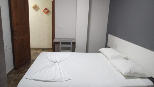 Pasto da MataPOUSADA TAHITI的一间卧室配有一张带白色床单和枕头的床。