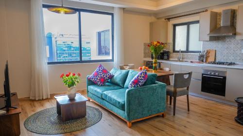 内罗毕Elite One Bedroom Apartment,Swimming pool, gym, workspace ,Wonderiss Homes Westland Living的带沙发和桌子的客厅以及厨房。