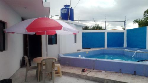 通苏帕Casa Tonsupa的游泳池旁的桌子和遮阳伞