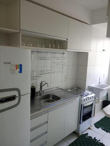 圣若泽-迪里巴马尔Apartamento 1 km da praia do aracagir confortavel的白色的厨房设有水槽和炉灶。