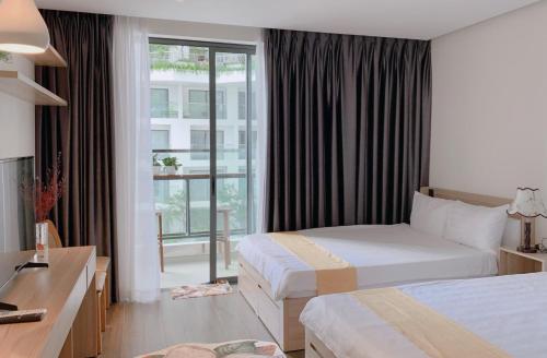 绥和市Apec mandala new Phú yên的酒店客房设有两张床和窗户。