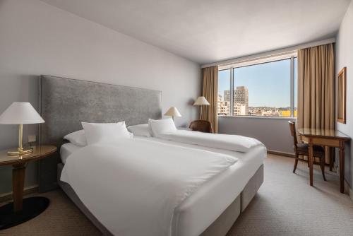卢布尔雅那Exe Lev的酒店客房设有两张床和大窗户。