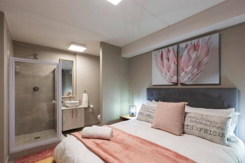 兰格班Nivica 56 Luxury Apartment Langebaan的一间卧室设有一张大床和淋浴