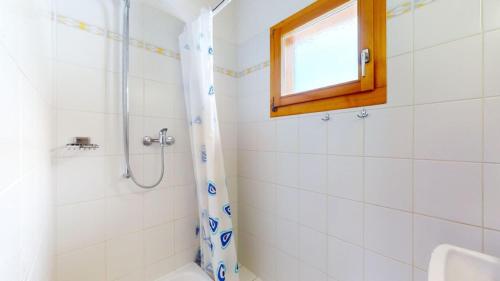 韦松纳Fontannets COSY & MOUNTAIN chalets的带淋浴的白色浴室和窗户。