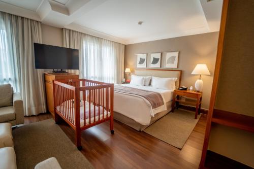 圣保罗乔治五世奥拓德皮涅罗斯酒店的配有一张床和一台平面电视的酒店客房
