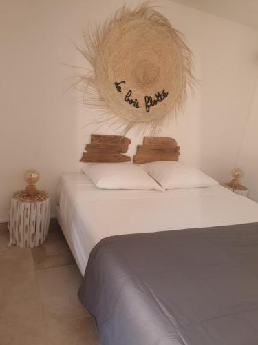 圣马迪拉莫Appartement LE BOIS FLOTTE的一间卧室,配有一张带标志的床