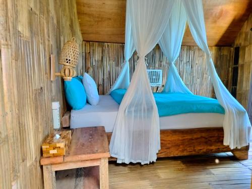 GitgitWanagiri sunset glamping的一间卧室配有一张带蚊帐的床