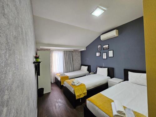 巴库Cityland Hotel Baku的酒店客房设有两张床和窗户。